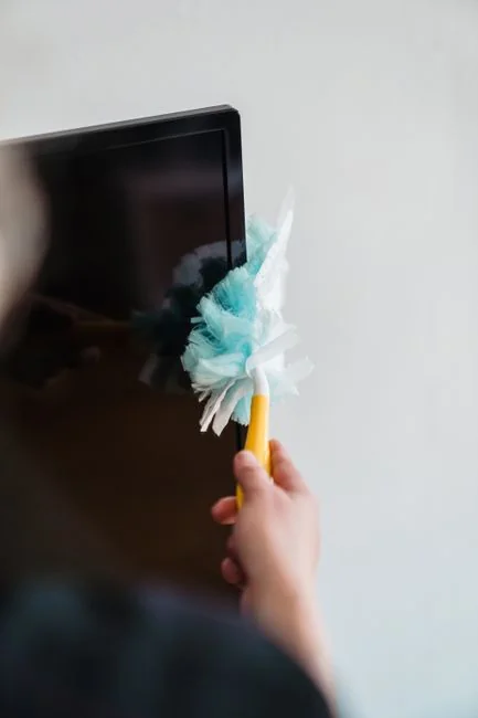 A person wearing personal protective equipment is vacuuming inside, making sure the space is cleaned thoroughly.